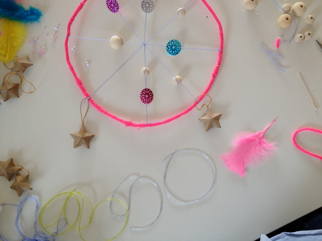 Add some pieces of yarn to the bottom portion of your dream catcher.