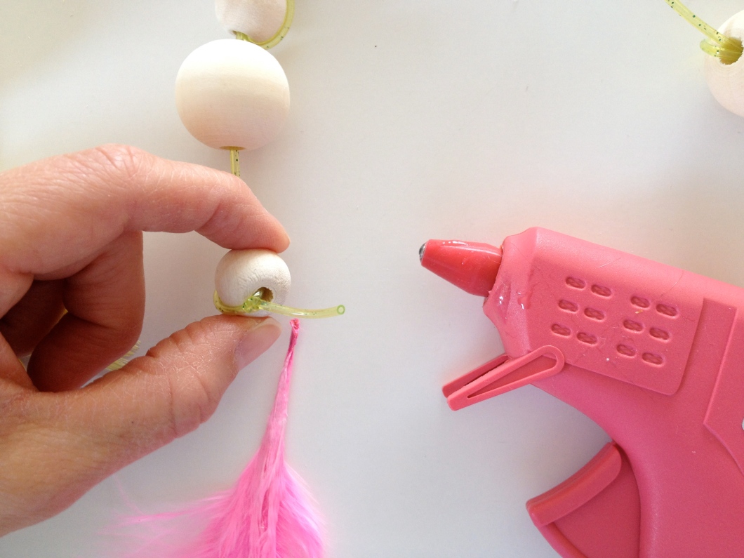 Add some hot glue to the inside of your beads...