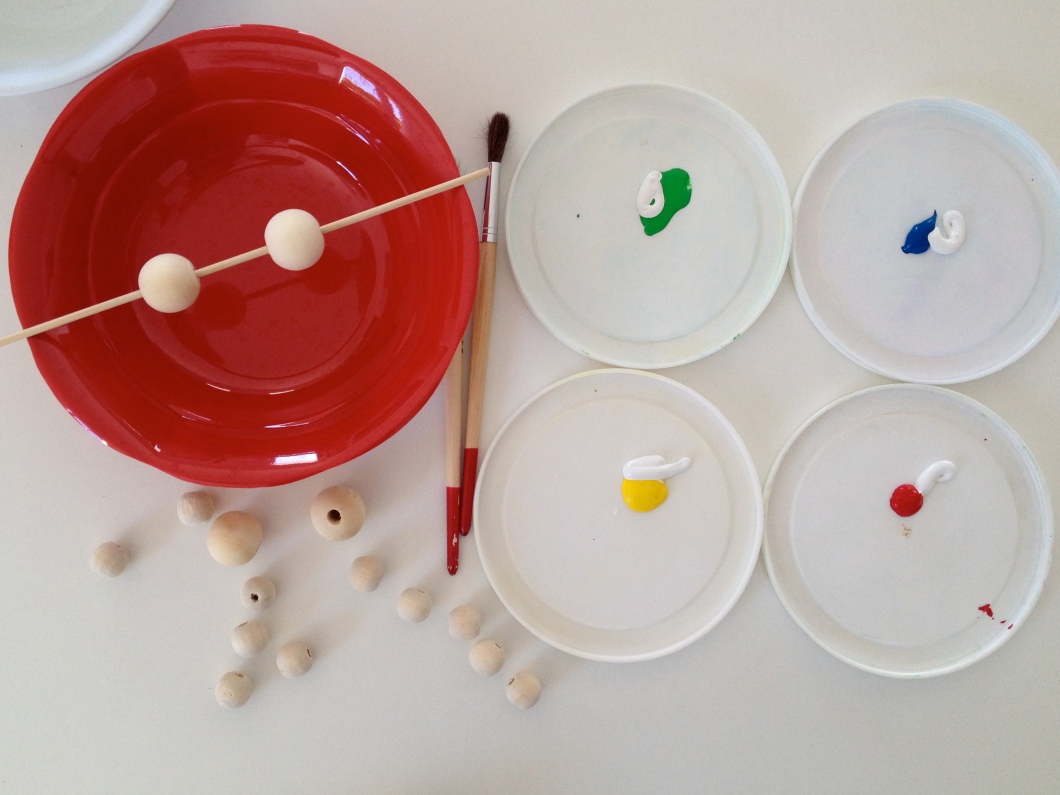 Use a skewer to make it easier to paint your beads.